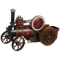 A handmade painted wood model steam engine, with iron-bound wheels and chain-driven movement, H33cm