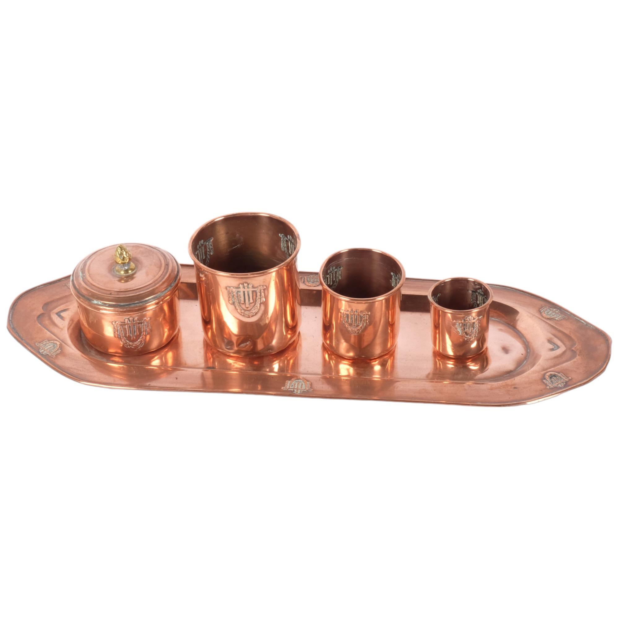 A French Art Nouveau copper tray of rectangular form, a graduated set of 3 matching beakers, and a
