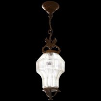 An Antique brass and glass panelled lantern style light fitting, with figural female bust sculptured