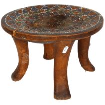 An African Ashanti carved wood stool, with beaded decoration to the top, 32.5cm across