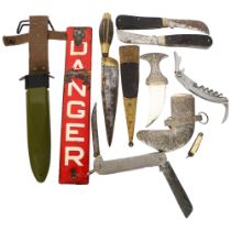 A group of various knives, including a small decorative Jambiya, a brass-bound Middle Eastern knife,