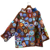 A Johnsons Sport & Leisure XXL brown denim cape covered with a large quantity of fishing related