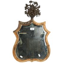 A Victorian dressing table mirror, shield-shaped with bevelled glass, and cast-metal topper