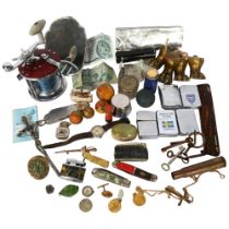 A box of miscellaneous items, including lighters, fishing reel, keys etc