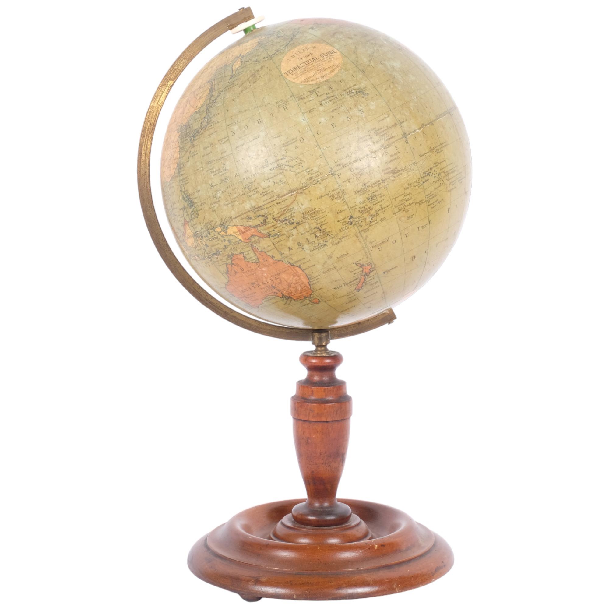 A Philip's 9" terrestrial globe on turned base, London Geographical Institute, H43cm Good overall