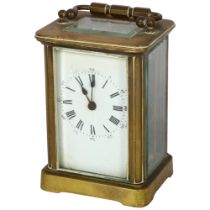 A French brass-cased carriage clock with enamel dial and Roman numerals, height not including handle