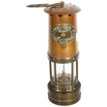 A miner's safety lamp, with inscription for E. Thomas & Williams Ltd, Cambran, maker's Aberdare,