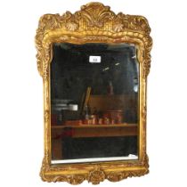An impressive French ornate wooden gilt wall mirror, 63cm x 41cm