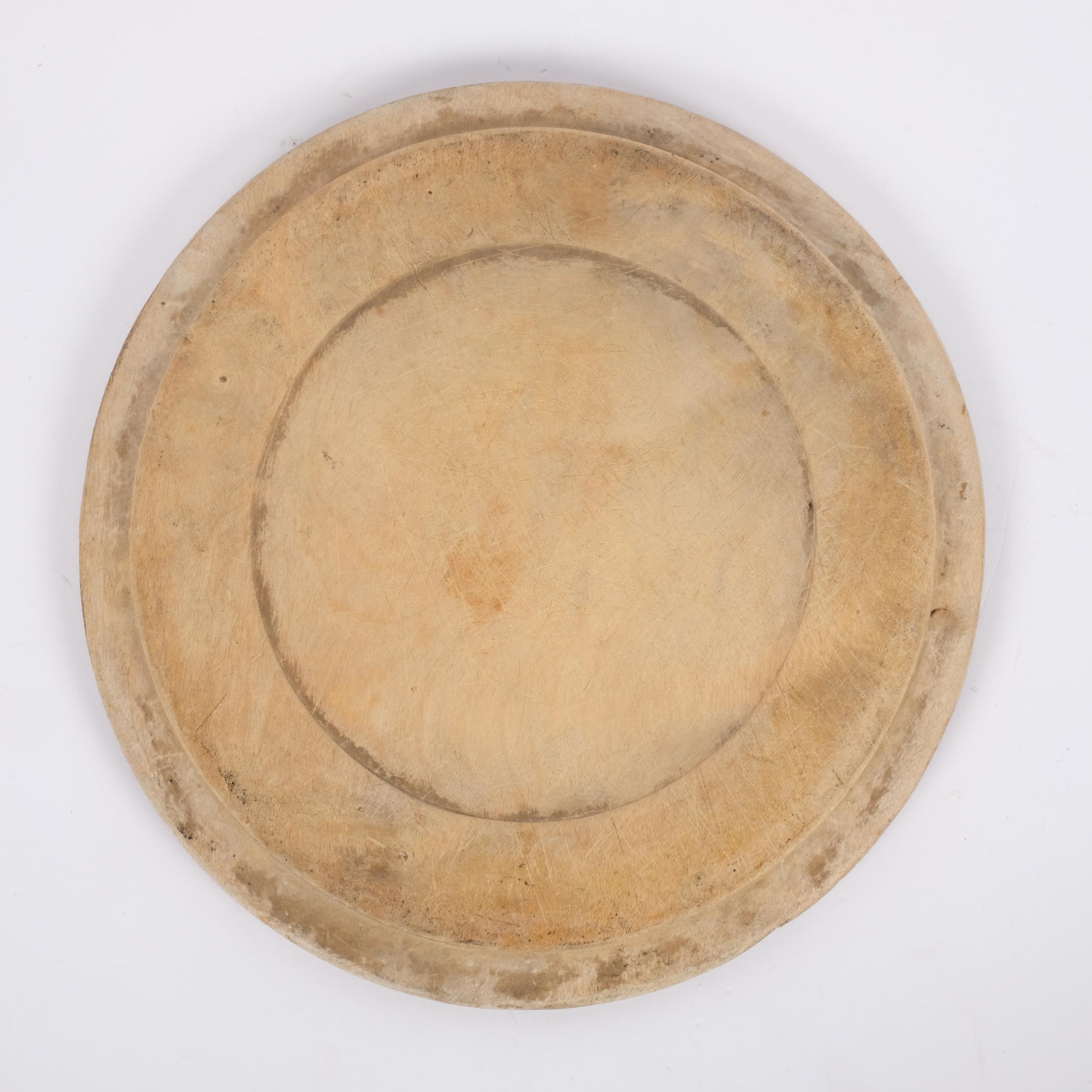 A 20th century bread board with carved decoration, diameter 29cm Board is in well-used condition, - Image 2 of 2