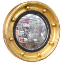 An Antique miniature giltwood convex wall mirror, with ball mounts, diameter 20cm