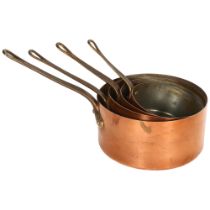 A graduated set of 4 Vintage copper saucepans, with brass handles, largest 18cm diameter