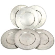 A set of 6 pewter platters, with decorated rims and touch marks, 32cm, with cloth bags