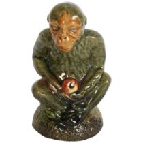 A green glazed study of a seated monkey, H14cm, indistinctly signed to the base