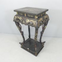 An oriental black lacquered lamp table, with painted dragon decoration and raised on pedestal