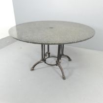A polished granite topped circular garden table on cast iron base. 130x71cm.