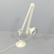 THOUSAND & ONE LTD. - A mid-century anglepoise lamp in cream finish. Turns on when plugged in. Not