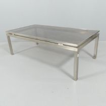 A mid-century French chrome framed coffee table with smoked glass top, in the manner of Guy