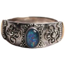 A 925 silver and 18ct gold banded dress ring, set with an oval opal