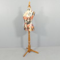 CLIVE FREDRIKSSON - a decoupage decorated mannequin of the female form on pine tripod stand,