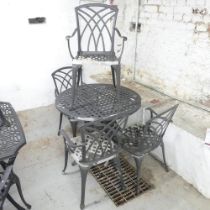 A painted metal circular garden table, 90xx72cm, and four matching chairs. Used condition. Several