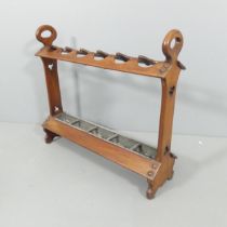 An antique mahogany Arts & Crafts gothic style stick / umbrella stand, with drip tray and pierced