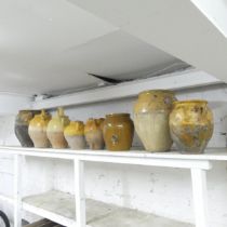 Eight various vintage French yellow part-glazed stoneware confit pots. Largest 35x35cm.