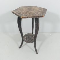 A Japanese Art Nouveau two-tier carved wood side table for Liberty & Co. circa 1900, with three wise