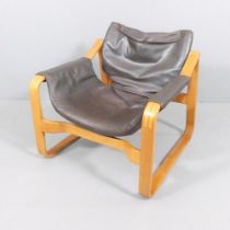 Maurice Prentice Burke, a rare leather lounge chair, the beech frame with sled base, with maker’s
