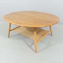 ERCOL - an elm model 454 oval two-tier coffee table. 100x44x83cm