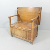 An early 20th century oak monk's bench, with lifting seat. Dimensions as table 77x63x46cm, back