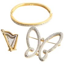 2 Swarovski brooches in the form of a harp and a stylised flower head, and a hinged bangle,