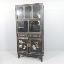 A Chinese black lacquered cabinet, with painted and applied hardstone decoration, five glazed