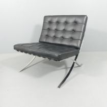 A black leather Barcelona lounge chair in the manner of Mies Van der Rohe. Overall 77x80x76cm,
