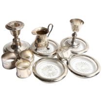 A group of silver and other items, including a squat silver candlestick with filled base, 4 napkin