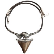 A Scandinavian shark's tooth pendant necklace, with white metal mounts and leather strap