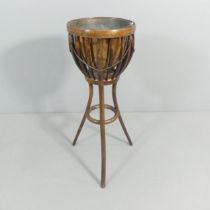 An early 20th century bentwood jardiniere stand with copper liner. 46x91cm. Good used condition.