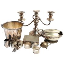 A silver plated shell spoon warmer, a table candelabra, ice bucket etc