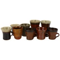 Leach Pottery, St Ives, a group of 9 mugs and beakers, most with pottery marks, some overglazed,