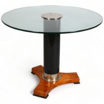 A mid/late 20th century Hollywood Regency style table, glass top on ebonised and burr wood base,