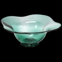 Simon Gate for Orrefors, Sweden, a 1930 designed large green glass footed bowl, marked to base