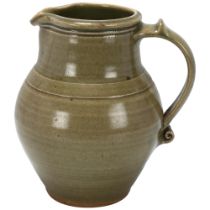 Leach Pottery, St Ives, a celadon glazed jug with scrolled handle, pottery stamp to base, 18.5cm