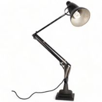 A Herbert Terry, black Anglepoise lamp, originally bench mounted, now mounted on two-step iron
