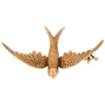 An Edwardian 15ct gold figural swallow bird brooch, realistically modelled in flight, wingspan 46.