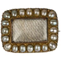 A Georgian split pearl mourning brooch, central dedication panel beneath convex glass within