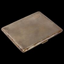 A sterling silver cigarette case, rectangular form, with allover engine turned decoration and gilt