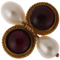 An Antique garnet and pearl Toi et Moi ring, unmarked gold closed-back settings with round