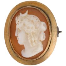 A 9ct gold shell cameo brooch, relief carved depicting Nyx Goddess of Night, 22.7mm, 3.1g Brooch