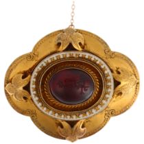 A Victorian garnet memorial brooch, centrally rub-over set with foil-back oval cabochon garnet, with