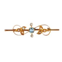 An Edwardian 15ct gold aquamarine pearl and diamond openwork brooch, rub-over set with 0.25ct
