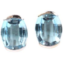 A pair of 18ct white gold blue topaz earrings, set with oval barrel-cut topaz with stud fittings,